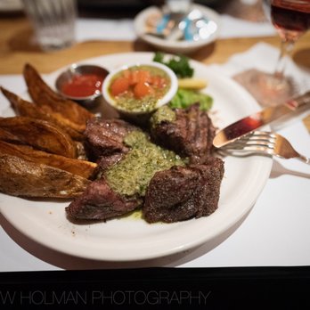 Club Paris signature dishes Filet Mignon, Prime Rib, Alaskan King Crab Legs, and Halibut Filet.